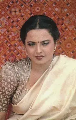 Rekha used to create fashion trends. Here she is seen in deep neck printed blouse with long sleeves