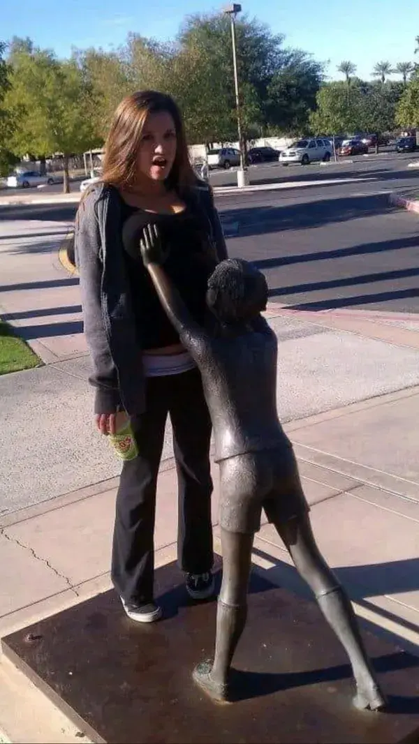 People Messing Around With Statues