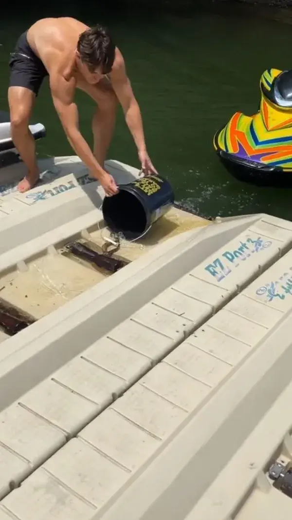 Guys are trying to catch snakes hiding under the jetski