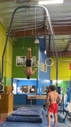 Gymnast's arm gets caught in the ring mid-flip