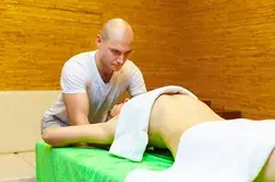 Masseur works on woman arms doing containing massage, treatment, and care