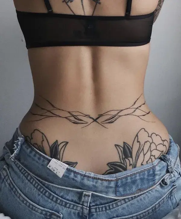 feminine symbolism in tattoos|moth-themed tattoo ideas|unique artistic ink|spooky and chic designs|e