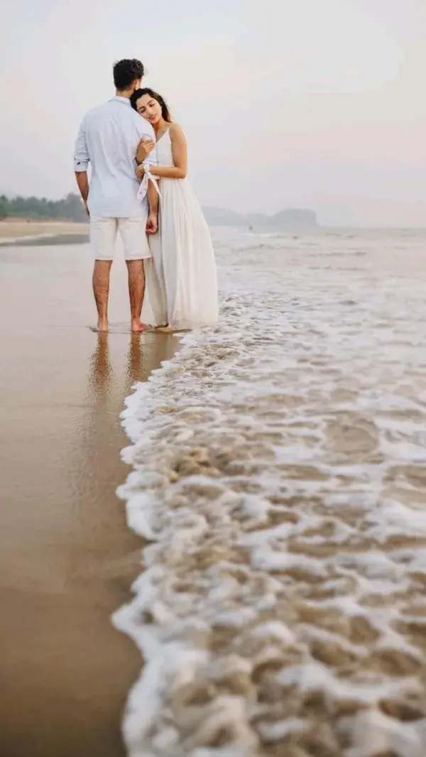 couple poses at beach