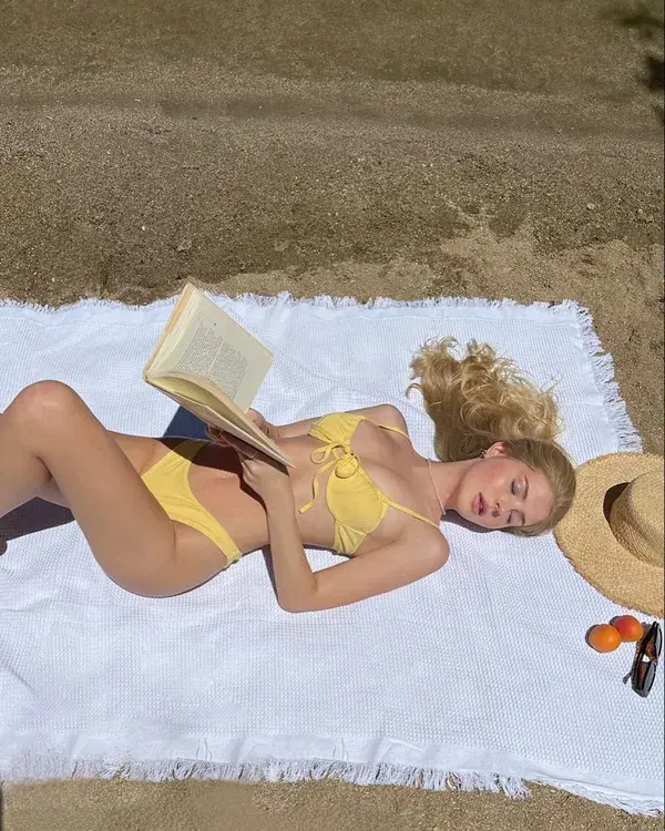 Girl reading while sunbathing