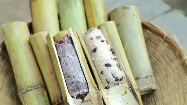 Sticky rice cook with coconut milk,sugar and black beans in bamboo stick  called Kaolam.