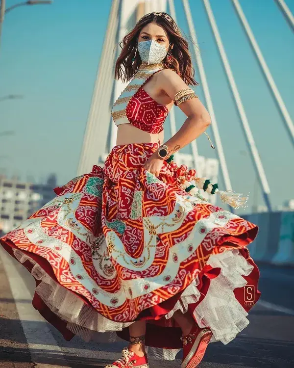 Drooling over these studded sneakers in red paired perfectly with the lehenga choli. 😍 