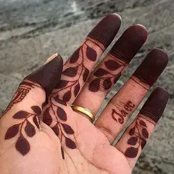 Dark mehndi stain on hands.