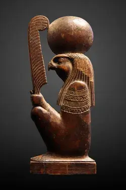 God Ra-Horakhty ('Ra, who is Horus of the Two Horizons') holding the feather of the goddess Maat.