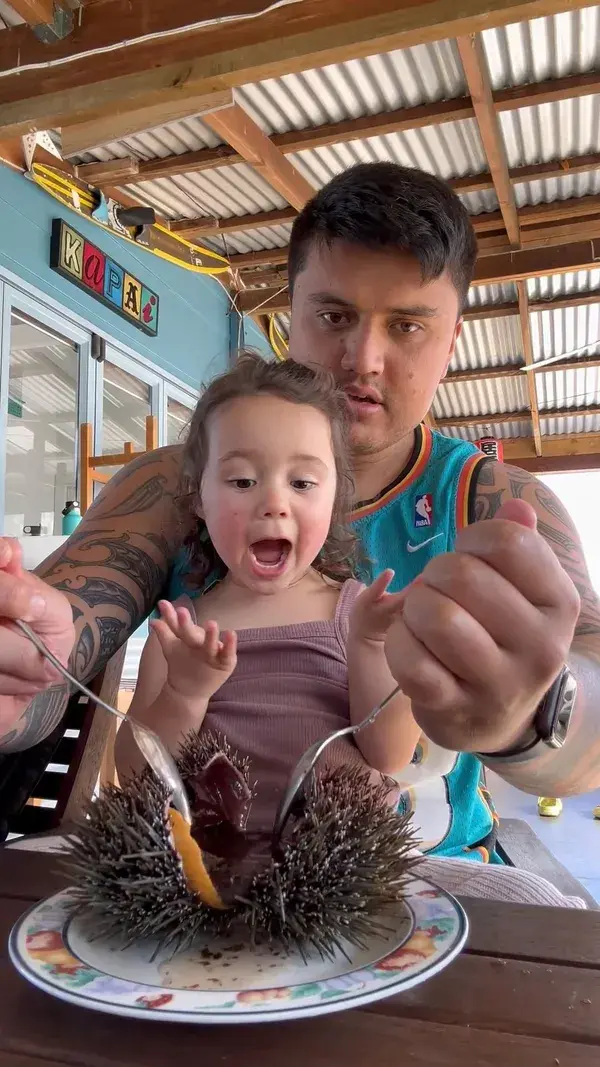 Louis’s daughter shows us how to eat kinas, which is Māori for sea urchin!