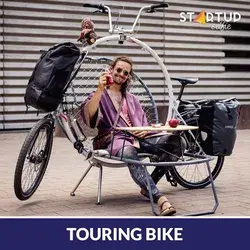 Touring bike features a built-in folding chair, table and cot