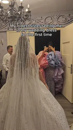 Woman reacts to seeing her sister in her wedding dress for the first time