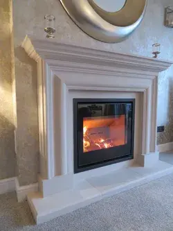 Scan 1001 inset wood burning stove in a bespoke Portland stone surround
