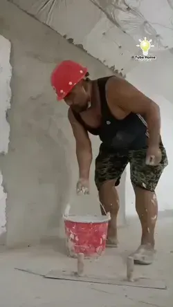 worker apply wall putty on wall - tube home