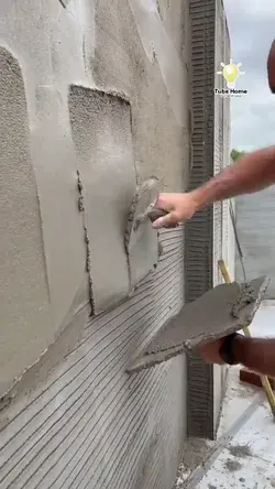 workers work on cement wall - tube home