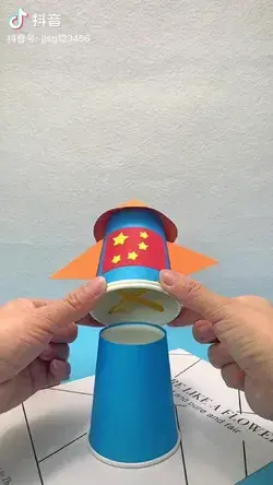 Rocket toy made by two paper cups with rubber bands
