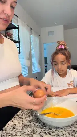 Mom cracks an egg on daughter's head, and she gets revenge