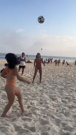 Brazilian girls are doing freestyle soccer tricks on the beach