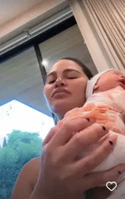 Chrissy Teigen breastfeeds newborn Esti while son Miles, 4, clambers over her and counts to 100 in hilarious video